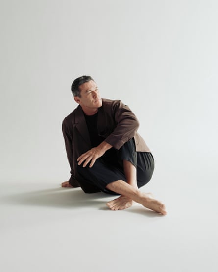 ‘There was never a point where I was ashamed.’ Portrait of Luke Evans sat on the floor wearing a casual suit and bare feet