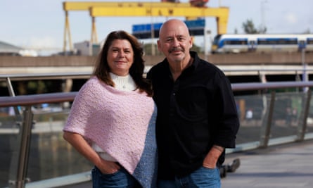 Angela Harsanyi and Gian Perroni stand near a dockyard with arms around each other