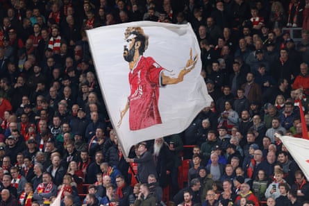 Fans wave a flag featuring Mohamed Salah