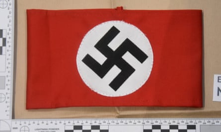 A red Nazi armband with a white circle and a black swastika