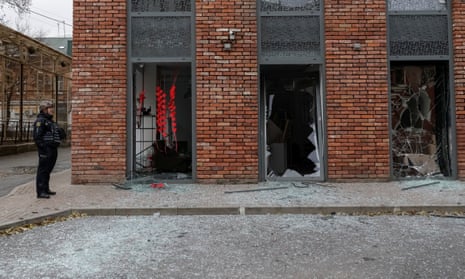 A police officer guards at a site of apartment buildings struck in the attack in Kharkiv.