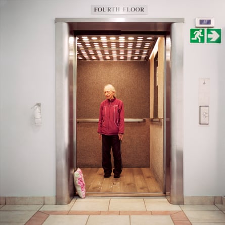 A woman stands in a lift, her hands by her sides