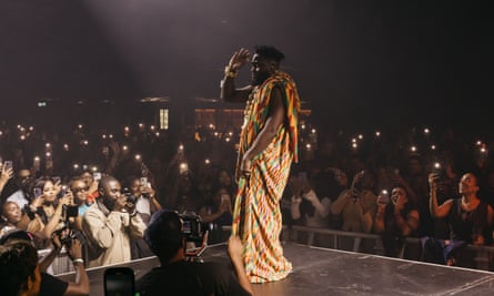 Juls on stage in front of a huge crowd