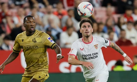 Sevilla’s Jose Ángel Carmona (right) with ‘Todos con Valencia’ written on his shirt.