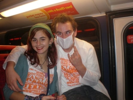 Nyika and a friend pose for a picture seated on the bus. The man alongside Nyika is wearing a surgical face mask and doing a ‘devil horns’ hand gesture