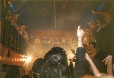 People dancing in Leeds Gallery nightclub. A balcony is above the dancefloor, and further up  is a glass roof