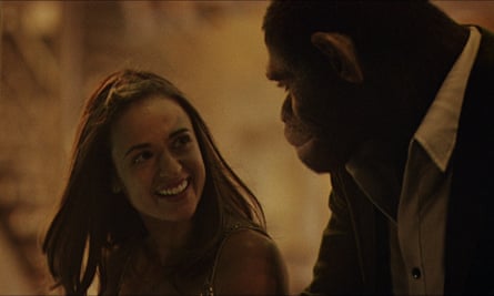 A CGI monkey portrays Robbie Williams in conversation with a female actor in the biopic Better Man.