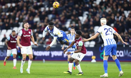 Brighton’s Carlos Baleba launches into a flying header.