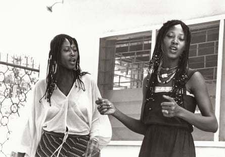 Black and white photograph of Taiwo and Kehinde Lijadu as young women, both wearing braids