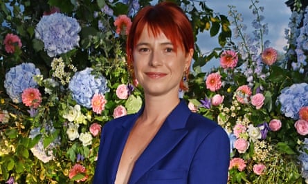 a woman against a flowery backdrop