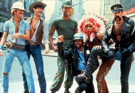 people in costume - a construction worker, cowboy, soldier, cop, a person in a headdress, and a biker