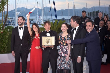 Sean Baker, third left, holds his Palme d’Or award at Cannes 2024, flanked by (l-r) Anora cast members Vache Tovmasyan, Samantha Quan, Mikey Madison, producer Alex Coco and Karren Karagulian.