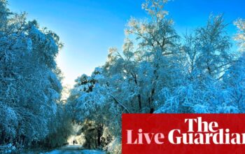 Parts of UK disrupted as snow and freezing rain arrive – live