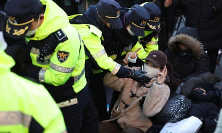 Police officers disperse pro-Yoon protesters