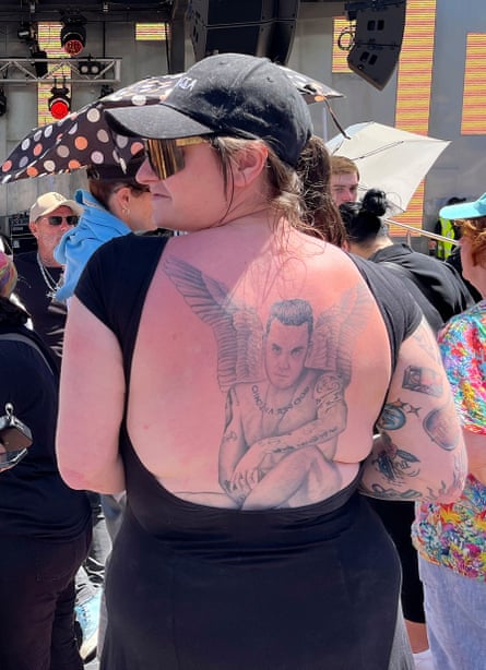 Robbie Williams fan Hazel shows off her back tattoo of the pop star ahead of his free concert at Federation Square in Melbourne on Thursday