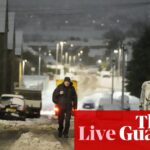 UK weather: ‘extensive flooding’ closes M5 in Gloucestershire as heavy snow and ice causes travel chaos across country – live