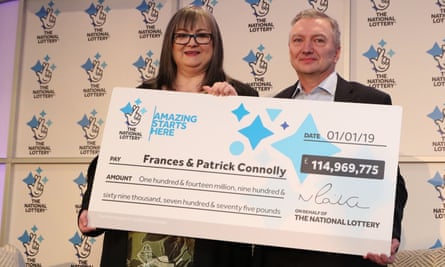 EuroMillions winners Frances and Patrick Connolly hold up the €115m cheque they won in 2019.