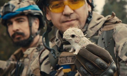 A Ukrainian soldier holding one of Anya Stasenko’s and Slava Leontyev’s miniature ceramic beasts