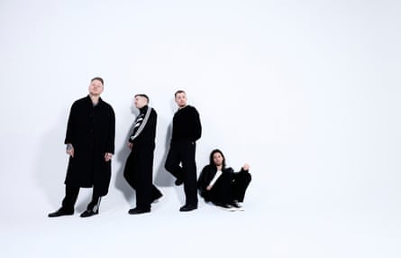 The band Architects standing in a line against a white background