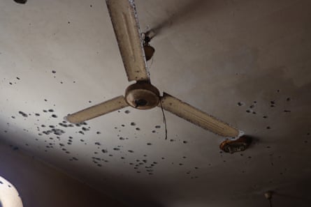 A ceiling pockmarked with holes 