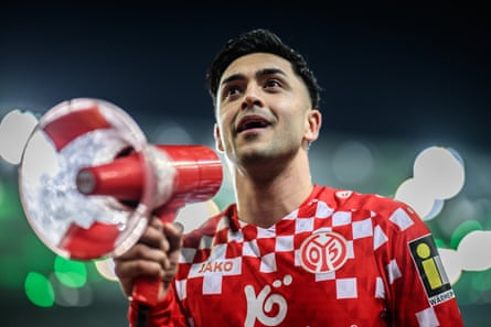 Nadiem Amiri holds a megaphone after the win for Mainz