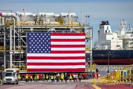 a giant American flag adorns an oil facility