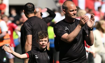 Liam Manning and his son, Isaac, applaud the fans at full-time as he does a lap of honour after the Championship match between Bristol and Preston at Ashton Gate