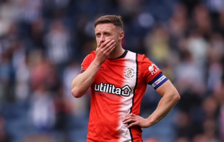 Luton captain Jordan Clark looks dejected after defeat confirmed their fall to League One.