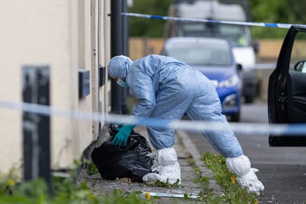 A police forensic officer searches a house in Rochdale on Sunday.