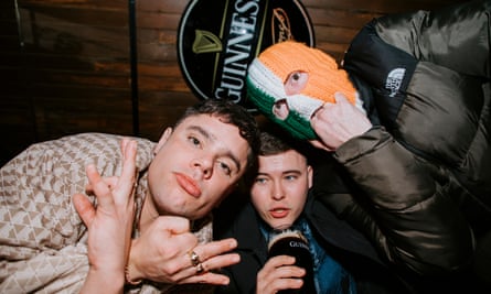 Kneecap posing in a bar