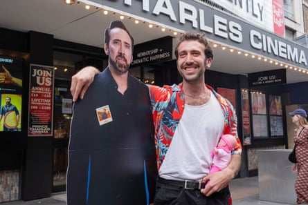 Daniel Breuer with a cardboard cutout of Cage at the Nicolas Cage lookalike event.