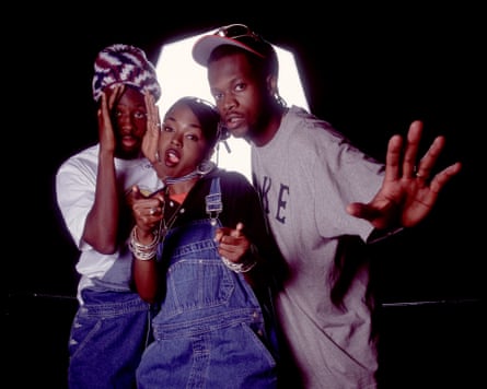 Wyclef Jean, Lauryn Hill and Pras as the band the Fugees, standing close together, with Hill pointing at the camera