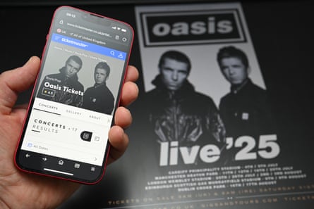 A fan tries to buy tickets for Oasis’s 2025 reunion tour using their smartphone